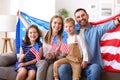 Young happy american family parents and two little kids Independence day of United States at home Royalty Free Stock Photo