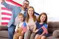 Young happy american family parents and two little kids Independence day of United States at home Royalty Free Stock Photo