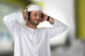 Young happy Arabian man with headphones listening to music Royalty Free Stock Photo