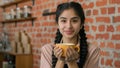 Young happy arabian woman enjoy fragrant drink in cafe smiling relaxed Indian girl restaurant customer enjoying