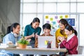 Young happy Asian business man, woman work together, celebrate clap hands in start up office. Creative team brainstorm meeting