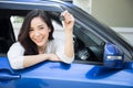 Young happy Asian car driver woman smiling and showing new car keys. Royalty Free Stock Photo