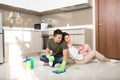 Young happy Asian couple is having fun while doing cleaning at home Royalty Free Stock Photo