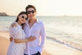 Young happy Asian couple hug on the beach, romantic travel honeymoon vacation summer holidays. Asian woman and man holding hands Royalty Free Stock Photo