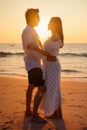 Young happy Asian couple looks at each other on the beach, romantic travel honeymoon vacation summer holidays. Asian woman and man Royalty Free Stock Photo