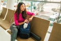 Young happy asian girl waiting for departure in international airport. Royalty Free Stock Photo