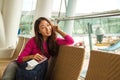 Young happy girl waiting for departure in international airport. Royalty Free Stock Photo