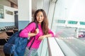 Young happy girl waiting for departure in international airport. Royalty Free Stock Photo