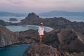 Young happy Asian man traveller standing on top view of Padar island in a morning sunrise, Komodo national park in Flores island, Royalty Free Stock Photo