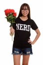 Young happy Asian nerd teenage girl smiling and holding red rose Royalty Free Stock Photo