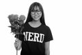 Young happy Asian nerd teenage girl smiling and holding red roses ready for Valentine`s day Royalty Free Stock Photo