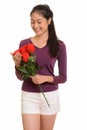 Young happy Asian teenage girl smiling holding red roses ready f Royalty Free Stock Photo