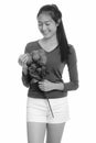 Young happy Asian teenage girl smiling holding red roses ready for Valentine`s day Royalty Free Stock Photo