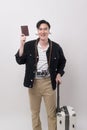 Young happy asian tourist man over white background studio, travel and holidays concept