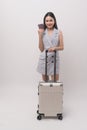 Young happy asian tourist woman over white background studio, travel and holidays concept Royalty Free Stock Photo