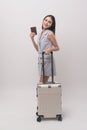 Young happy asian tourist woman over white background studio, travel and holidays concept Royalty Free Stock Photo