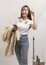 Young happy asian tourist woman over white background studio, travel and holidays concept Royalty Free Stock Photo
