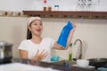 Young happy Asian woman doing domestic chores - beautiful sweet and cute Chinese girl washing dishes in kitchen smiling relaxed Royalty Free Stock Photo