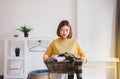 Young happy asian woman doing laundry with basket at home Royalty Free Stock Photo