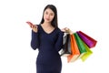 Young happy Asian woman holding shopping bags with smiley face isolated on white Royalty Free Stock Photo
