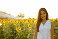 Young happy Asian woman smiling in the field of blooming sunflow Royalty Free Stock Photo