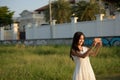 Young happy Asian woman smiling while taking selfie picture with Royalty Free Stock Photo