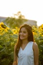 Young happy Asian woman smiling and thinking while looking at di Royalty Free Stock Photo