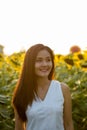 Young happy Asian woman smiling and thinking while looking at di Royalty Free Stock Photo