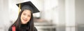 Young happy Asian woman university graduate in graduation gown and cap in the college campus. Education stock photo Royalty Free Stock Photo