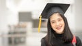 Young happy Asian woman university graduate in graduation gown and cap in the college campus. Education stock photo Royalty Free Stock Photo