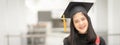 Young happy Asian woman university graduate in graduation gown and cap in the college campus. Education stock photo Royalty Free Stock Photo