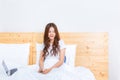 Young happy asian woman waking in her brightly lit bedroom using Royalty Free Stock Photo