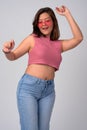 Young happy Asian woman wearing heart shaped glasses and dancing Royalty Free Stock Photo