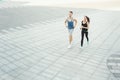 Young woman and man running in city copy space Royalty Free Stock Photo