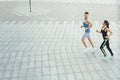 Young woman and man jogging in city copy space Royalty Free Stock Photo