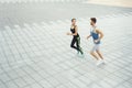 Young woman and man running in city copy space Royalty Free Stock Photo