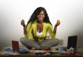 Young happy and attractive African American business woman doing yoga sitting at office messy desk full of paperwork smiling relax Royalty Free Stock Photo