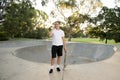Young happy and attractive American man 30s standing holding skate board after sport boarding training session talking on mobile p