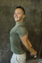 Young happy and attractive Asian American man on his 20s smiling confident and positive stretching body before gym workout Royalty Free Stock Photo