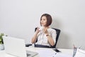 Young happy and attractive asian business woman working at office computer desk smiling drinking cup of coffee relaxed and Royalty Free Stock Photo