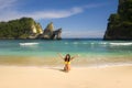 Young happy and attractive Asian Japanese woman in bikini excited at paradise beach sitting on sand by the sea enjoying idyllic