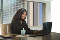 Young happy and attractive black African American businesswoman working confident at computer desk smiling satisfied in financial Royalty Free Stock Photo