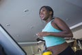 Young happy and attractive black African American woman at gym running on treadmill machine smiling cheerful and sweaty in gym tra Royalty Free Stock Photo