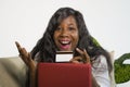 Young happy and attractive black African American woman using credit card and laptop computer banking online and shopping on inter Royalty Free Stock Photo