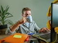 Young happy and attractive business man at home office drinking coffee cup looking satisfied and confident working with laptop com Royalty Free Stock Photo