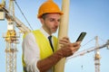 Young happy and attractive engineer or building contractor holding blueprints wearing constructor hardhat smiling confident Royalty Free Stock Photo