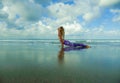 Young happy and attractive fit and skinny blond woman doing yoga and relaxation exercise outdoors at beautiful beach in relax and Royalty Free Stock Photo