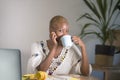 Young happy and attractive hipster black afro American woman drinking tea or coffee at home office working cheerful with laptop co Royalty Free Stock Photo