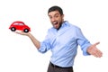 Young happy attractive man pointing big red toy car on his hand Royalty Free Stock Photo