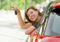 Young happy attractive woman smiling proud sitting at driver seat holding and showing car key in new automobile buy and rent conce Royalty Free Stock Photo